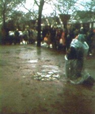 Veronica kneeling on the mud